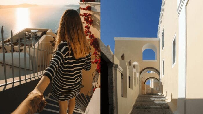Couple walking hand-in-hand through sunlit Santorini alleys with caldera views and charming Cycladic architecture.
