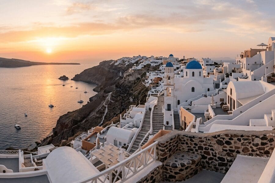 Panoramic view of the Oia caldera and Aegean Sea at sunset, the iconic backdrop for a Santorini proposal