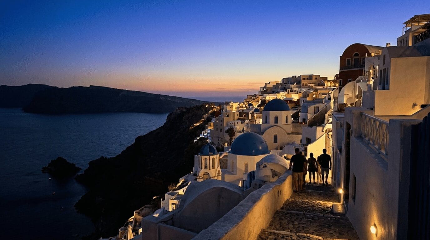 Oia village in Santorini glowing during blue hour after sunset, the calmest time to enjoy the caldera