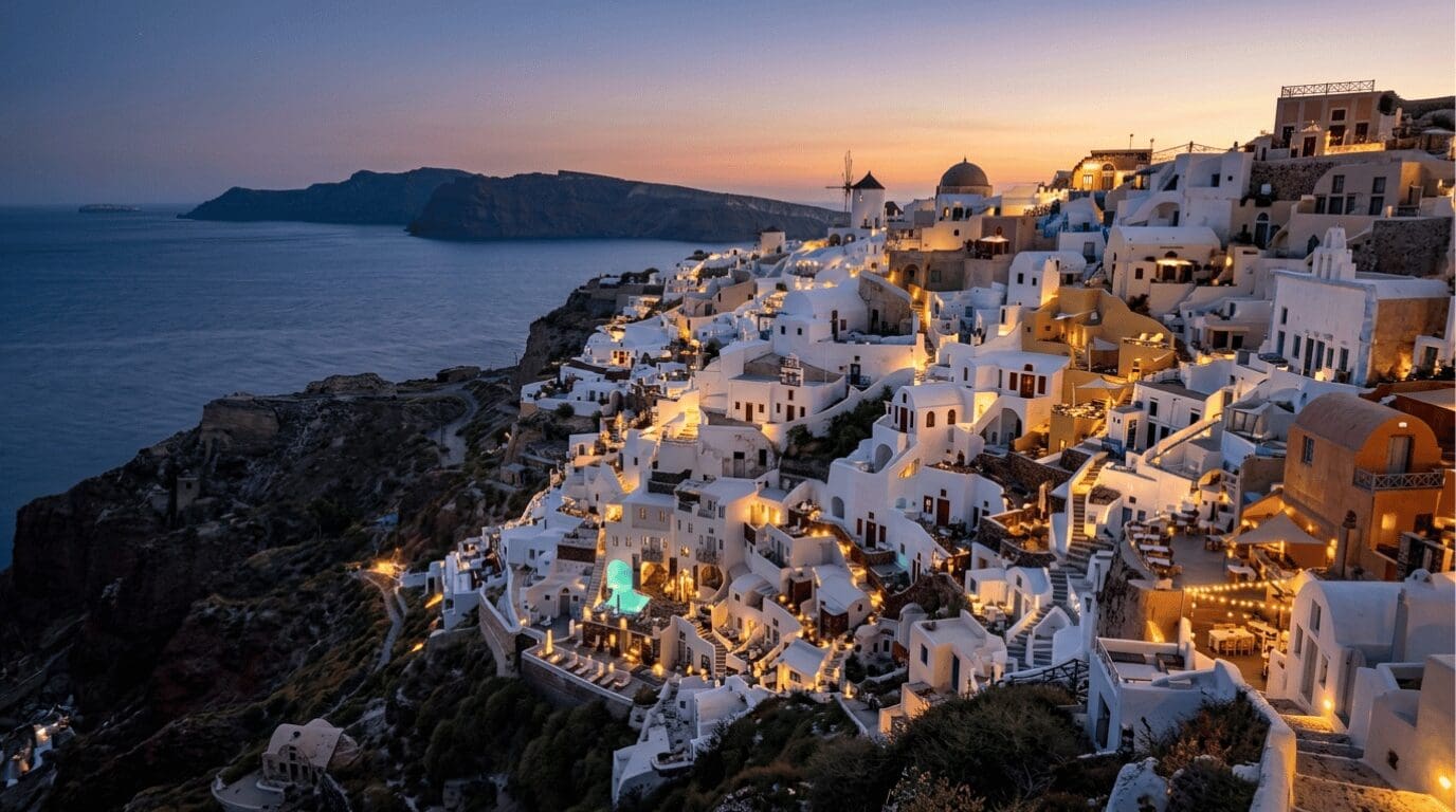 Oia Santorini caldera cliffside restaurants glowing at blue hour just after sunset
